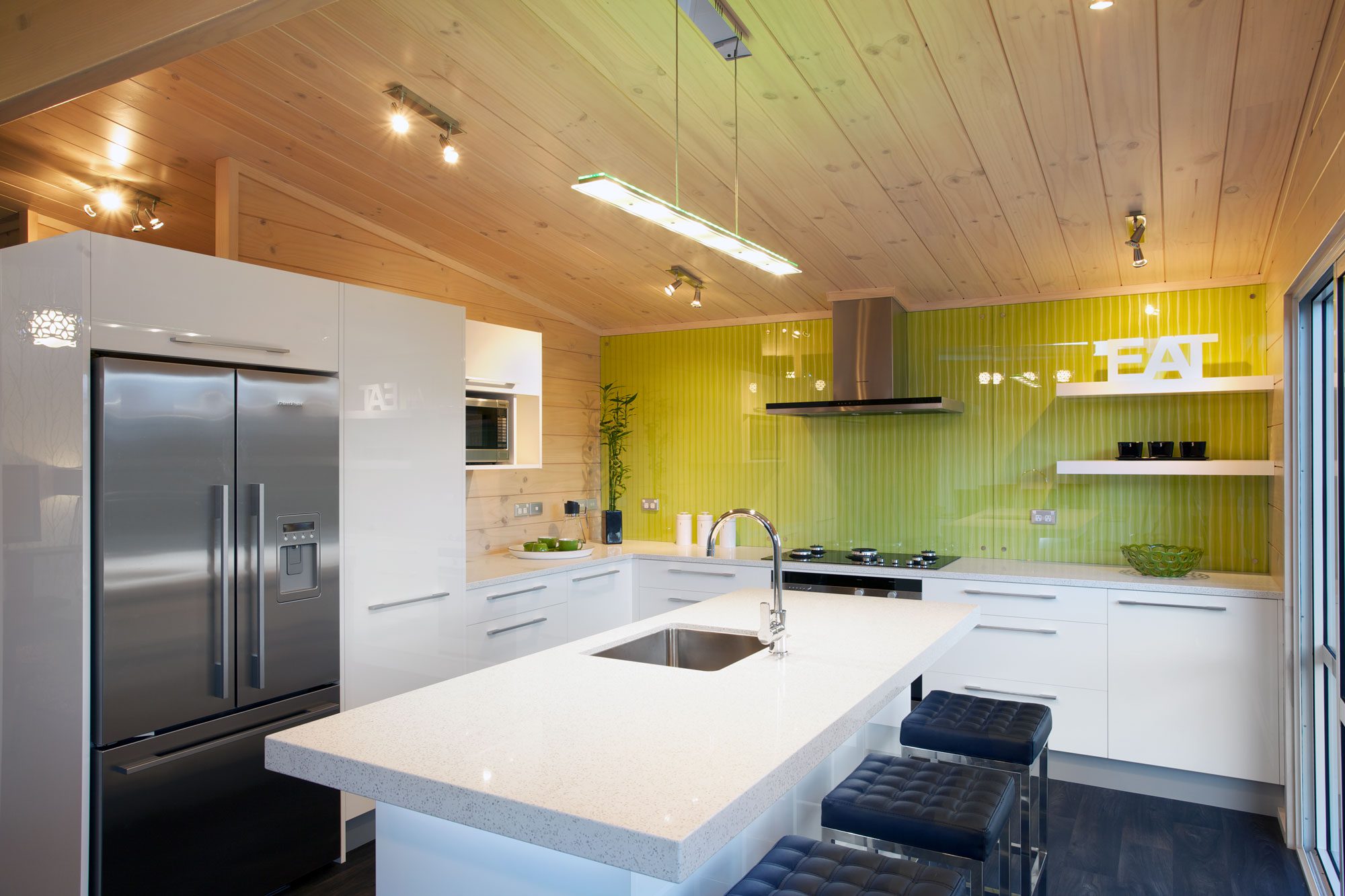 Bright green splashback in a Lockwood open plan kitchen
