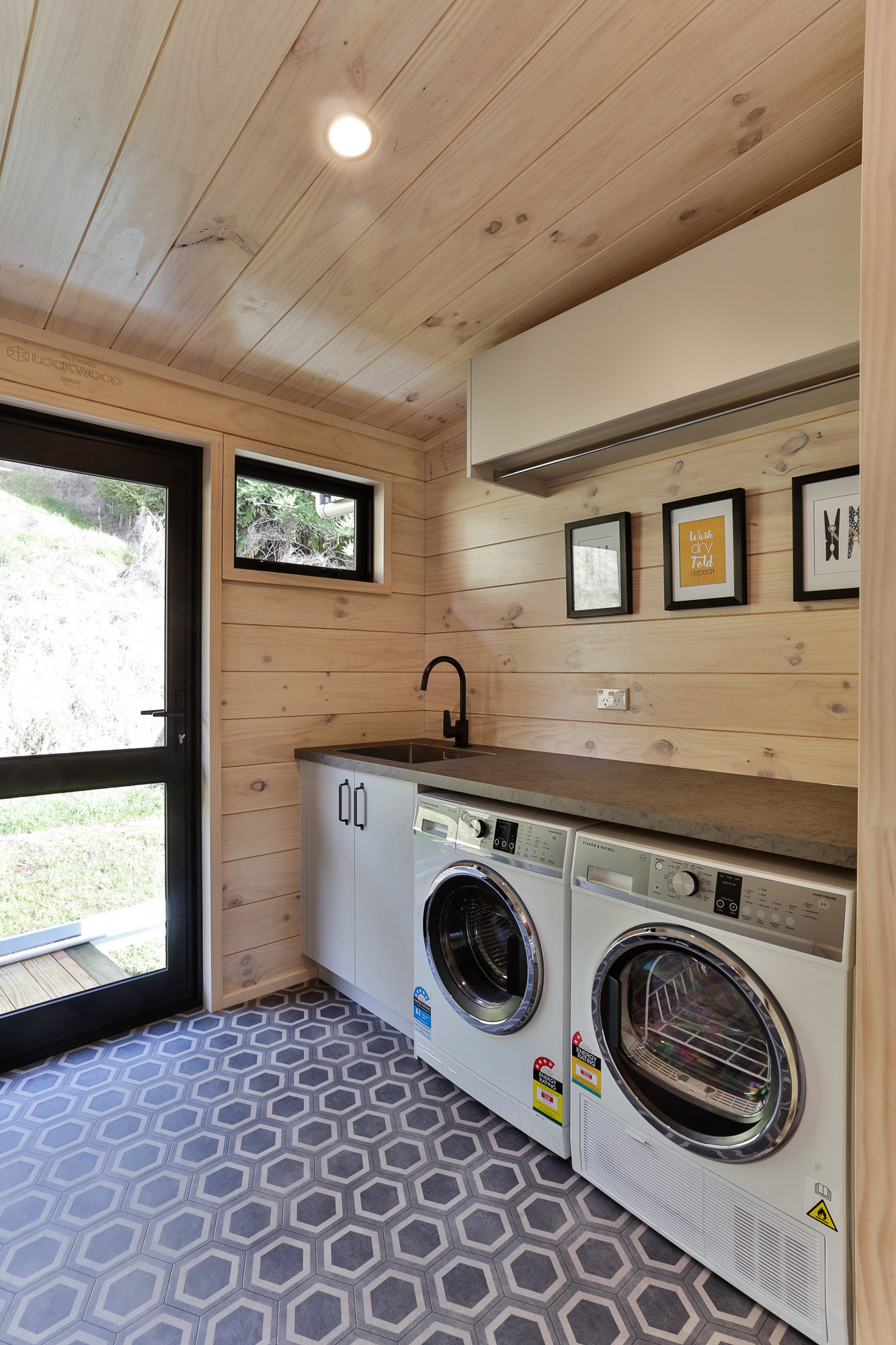 Lockwood Laundry with benchtop and high cupboards